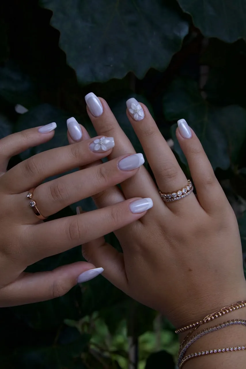 Soft pearl-white nails with sculpted 3D flower detail
